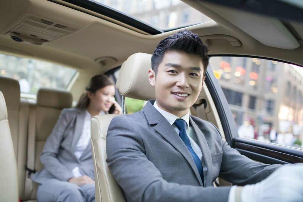 Chauffeur driving car for a businesswoman